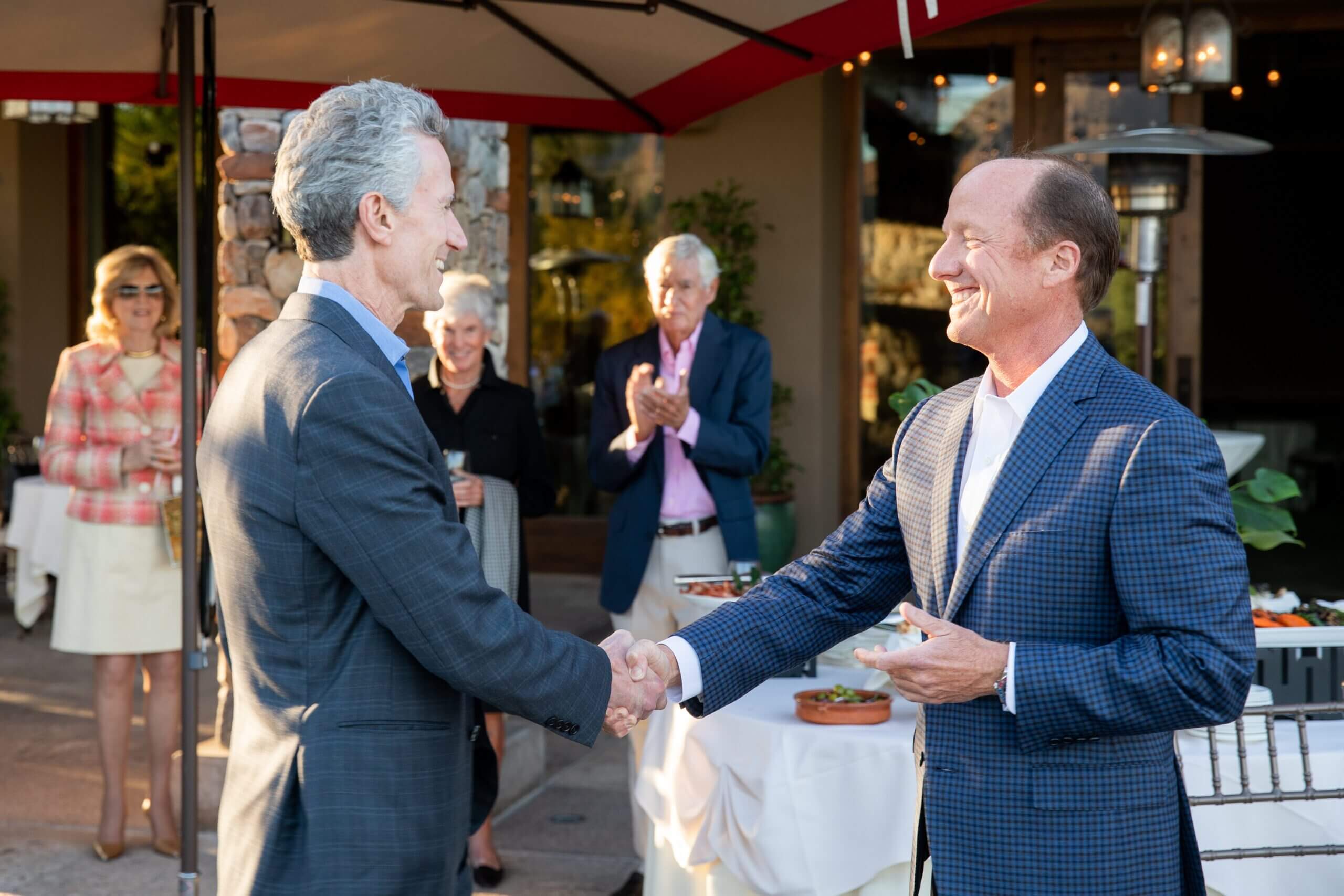 Dr. Lawton shaking hand with Board member