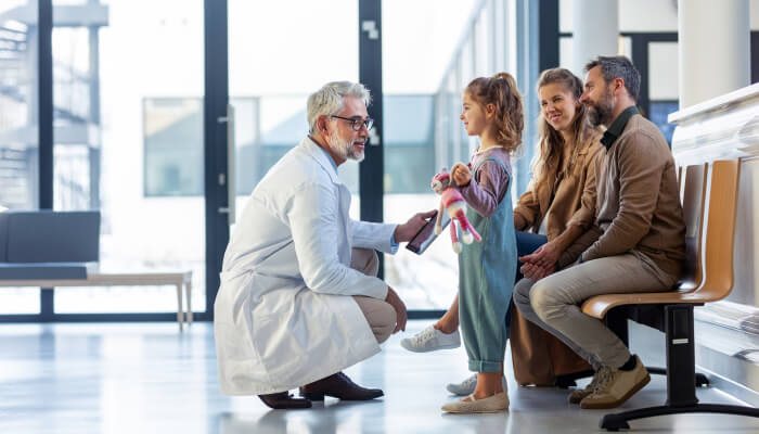 Doctor Crouches to a Little Girls